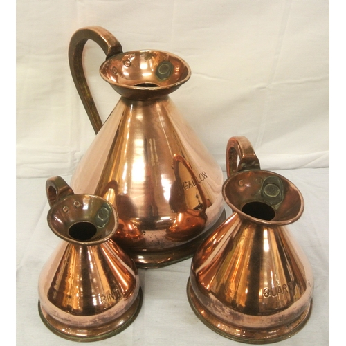 128 - Set of three Georgian style copper measures with shaped handles