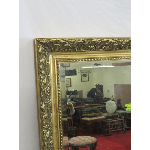 133 - Large gilt framed bevelled glass wall mirror with foliate & beaded decoration 130x100cm