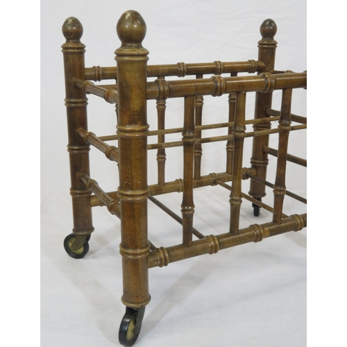 176 - Oriental style bamboo effect canterbury with shaped finials & on castors