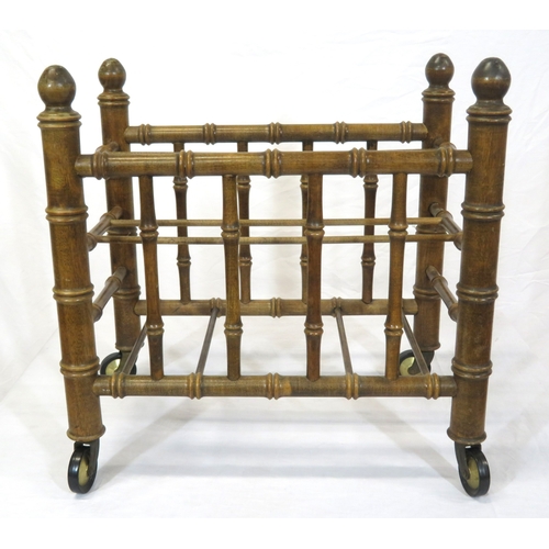 176 - Oriental style bamboo effect canterbury with shaped finials & on castors