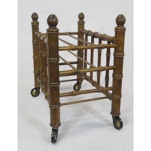 176 - Oriental style bamboo effect canterbury with shaped finials & on castors