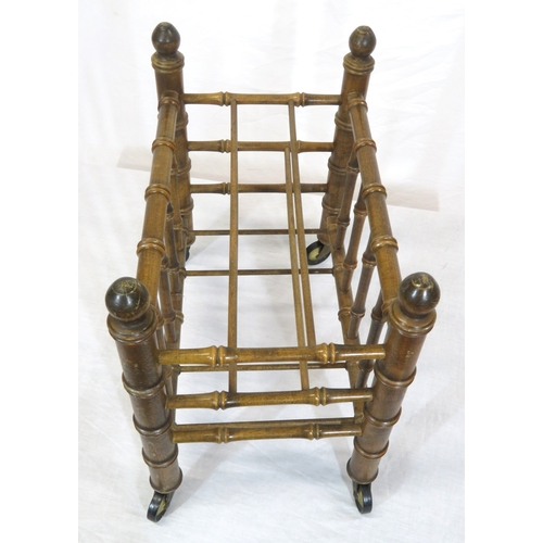 176 - Oriental style bamboo effect canterbury with shaped finials & on castors