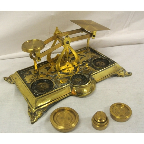 197 - Edwardian brass postal scales with weights, on oblong base with shaped feet