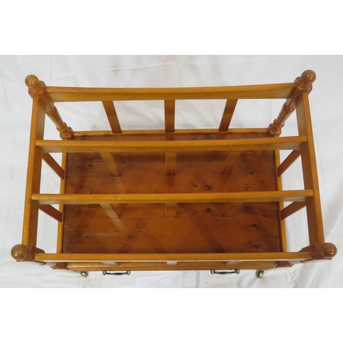 219 - Edwardian style yew three section canterbury with shaped rails, turned columns, drawer with brass dr... 