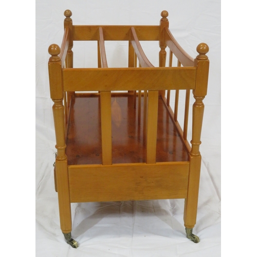 219 - Edwardian style yew three section canterbury with shaped rails, turned columns, drawer with brass dr... 