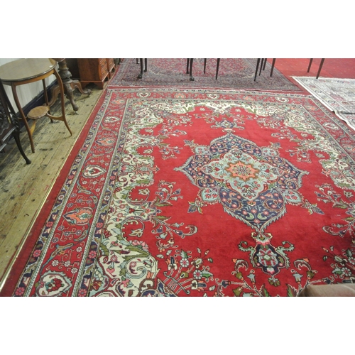 239 - Large multi coloured field Persian Tabriz carpet with rich colours on a floral field 380x290cm