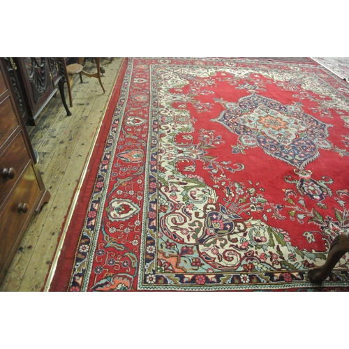 239 - Large multi coloured field Persian Tabriz carpet with rich colours on a floral field 380x290cm