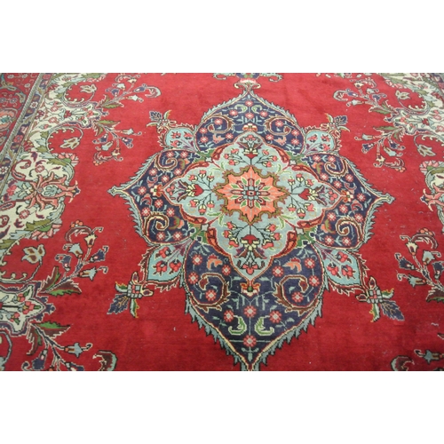 239 - Large multi coloured field Persian Tabriz carpet with rich colours on a floral field 380x290cm