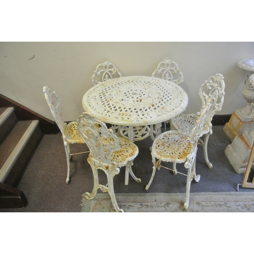 275 - Seven piece cast iron garden or patio suite - round table & six chairs with ornate foliate decoratio... 