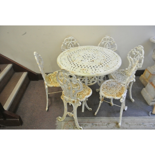 275 - Seven piece cast iron garden or patio suite - round table & six chairs with ornate foliate decoratio... 