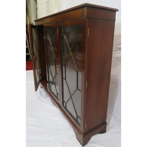 65 - Edwardian style mahogany bookcase with astragal glazed doors, adjustable shelving, on bracket feet