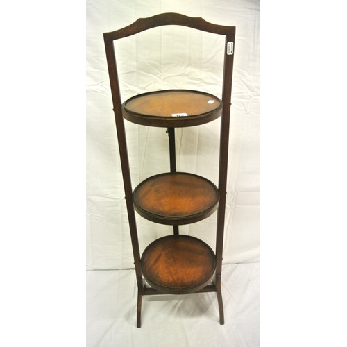 63 - Edwardian mahogany three tier round adjustable plate stand with shaped legs