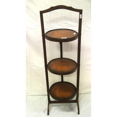 63 - Edwardian mahogany three tier round adjustable plate stand with shaped legs