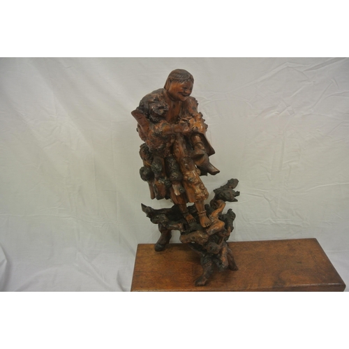 102 - Oriental carved figure with shaped base, on oblong plinth, 56cmH