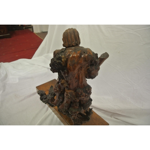 102 - Oriental carved figure with shaped base, on oblong plinth, 56cmH