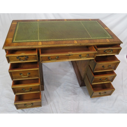 120 - Edwardian style yew kneehole desk with three frieze drawers, six side drawers, brass drop handles, o... 