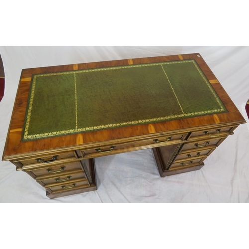 120 - Edwardian style yew kneehole desk with three frieze drawers, six side drawers, brass drop handles, o... 