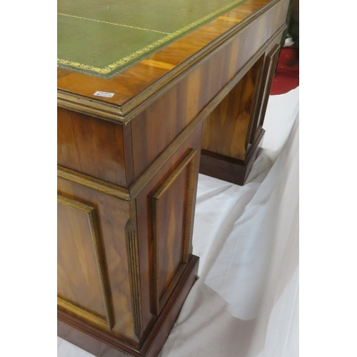 120 - Edwardian style yew kneehole desk with three frieze drawers, six side drawers, brass drop handles, o... 