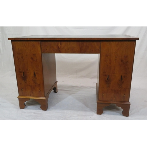 145 - Edwardian style serpentine fronted yew pedestal desk with shaped drawers, brass drop handles, on bra... 