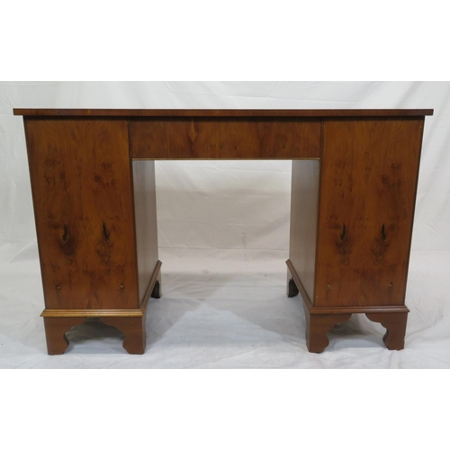 145 - Edwardian style serpentine fronted yew pedestal desk with shaped drawers, brass drop handles, on bra... 