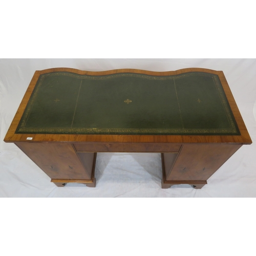 145 - Edwardian style serpentine fronted yew pedestal desk with shaped drawers, brass drop handles, on bra... 