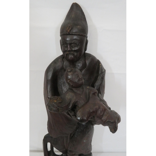 163 - Ornate Oriental carving of Gentleman with Child on shaped base