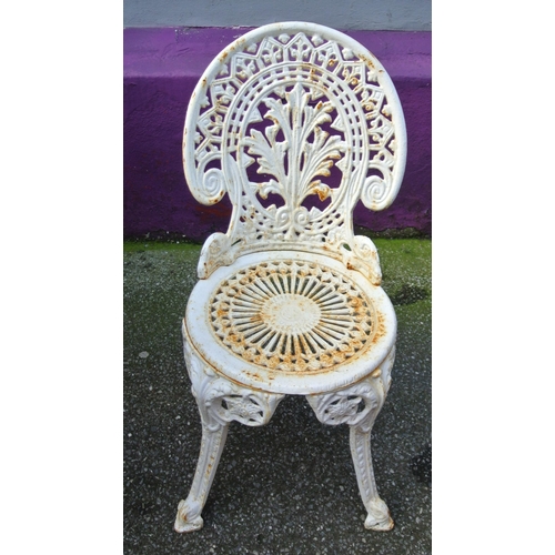 172 - Ornate cast iron four piece patio or garden suite - round table with rose decoration & four chairs w... 