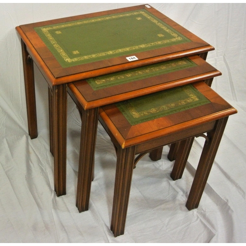 184 - Nest of three Edwardian style walnut tables with leatherette insets, on reeded legs