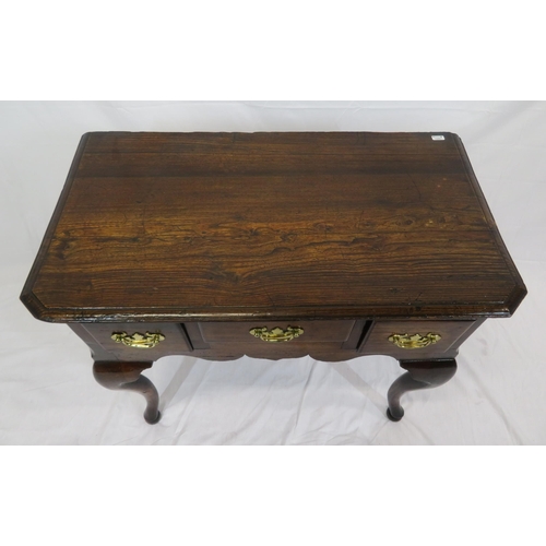 186 - Georgian oak lowboy with three frieze drawers, brass drop handles with shaped backplates, on cabriol... 