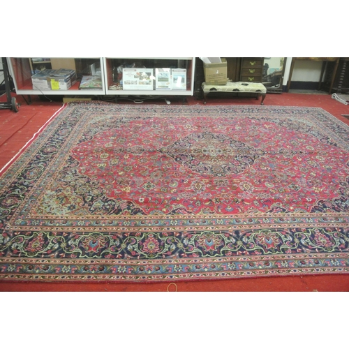 194 - Large rich pink ground Persian Kerman carpet multi coloured with floral medallion design 386x292cm