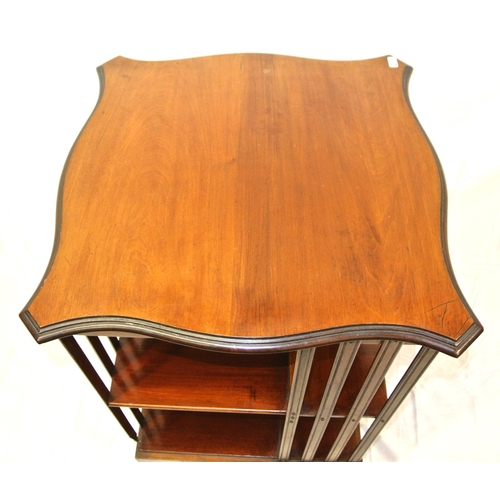 241 - Edwardian mahogany revolving bookcase with serpentine top, reeded rails, on quadrapod