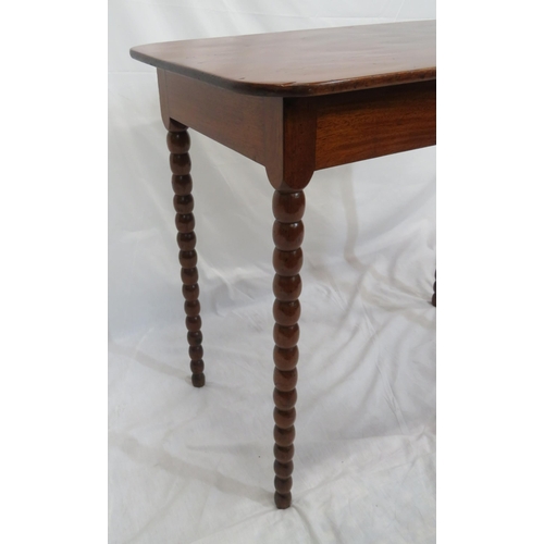 256 - Victorian mahogany oblong occasional table with rounded borders, raised on ball turned legs