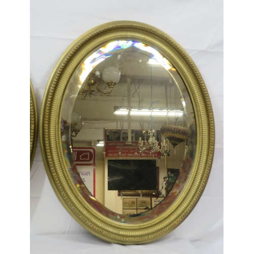 264 - Pair of Regency design oval bevelled glass wall mirrors with reeded & beaded decoration