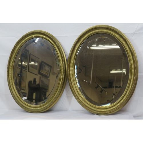 264 - Pair of Regency design oval bevelled glass wall mirrors with reeded & beaded decoration