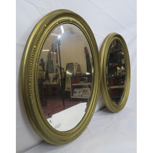 264 - Pair of Regency design oval bevelled glass wall mirrors with reeded & beaded decoration