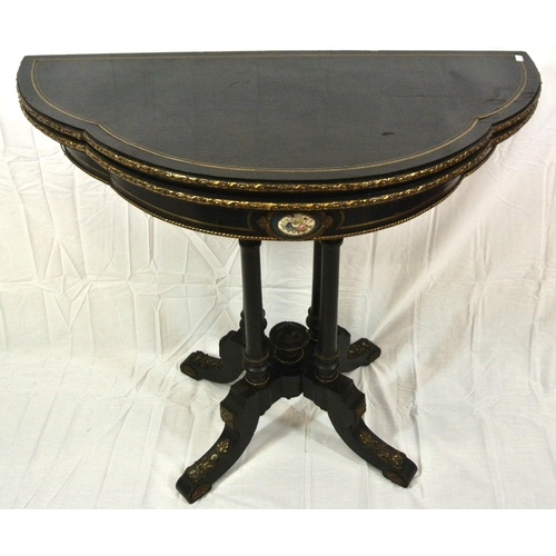 295 - Louis XV style inlaid ebonised card table of serpentine demi-lune form, with brass inlay, ormolu bor... 