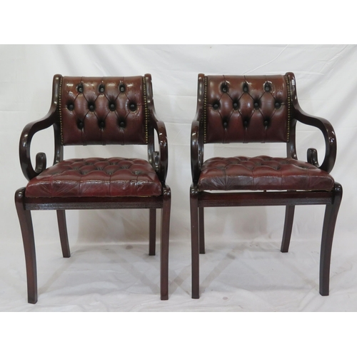 354 - Pair of Regency design open armchairs with buttoned leather upholstery, scroll arms, on sabre legs