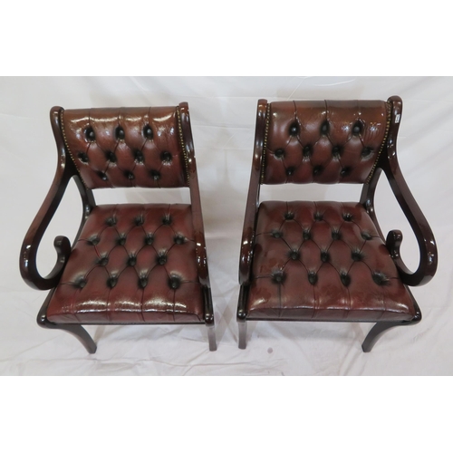 354 - Pair of Regency design open armchairs with buttoned leather upholstery, scroll arms, on sabre legs