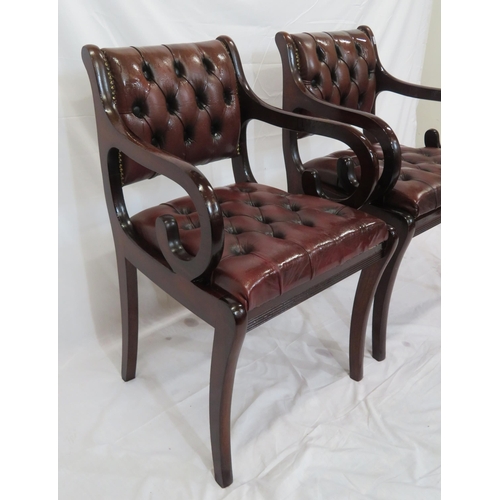 354 - Pair of Regency design open armchairs with buttoned leather upholstery, scroll arms, on sabre legs