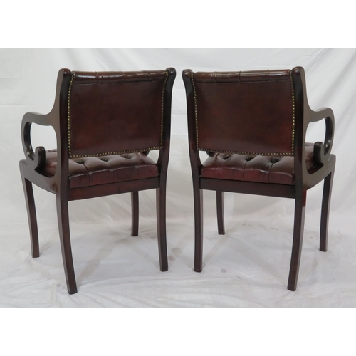 354 - Pair of Regency design open armchairs with buttoned leather upholstery, scroll arms, on sabre legs