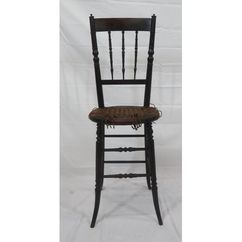 357 - Arts & Crafts high chair with turned spindles, wicker seat, turned legs with stretchers