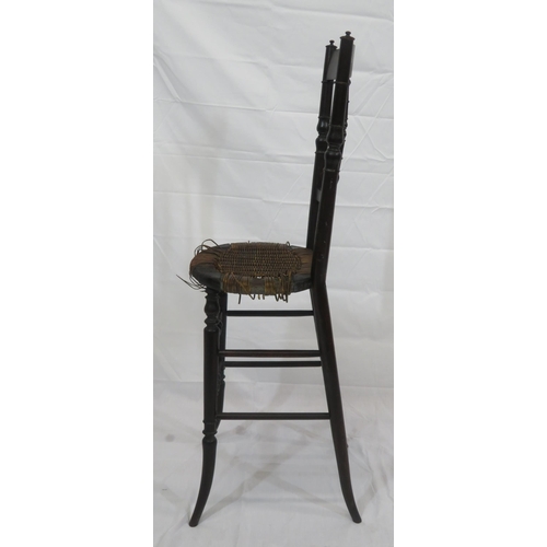 357 - Arts & Crafts high chair with turned spindles, wicker seat, turned legs with stretchers