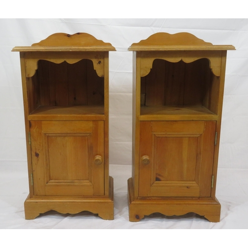 84 - Pair of pine bedside lockers with shaped backs, panelled doors, on bracket feet