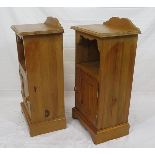 84 - Pair of pine bedside lockers with shaped backs, panelled doors, on bracket feet