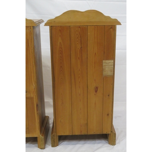 84 - Pair of pine bedside lockers with shaped backs, panelled doors, on bracket feet