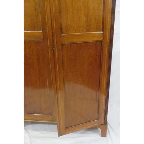 85 - Edwardian inlaid small wardrobe with shaped pediment, panelled doors, fitted with hanging, on bracke... 