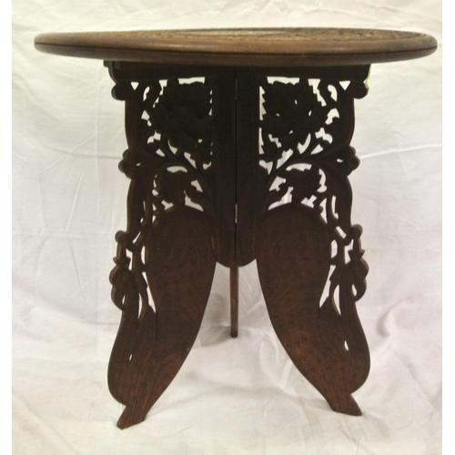 93 - Round Indian occasional table with foliate carving & folding base