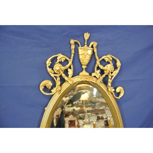 142 - Regency style oval bevelled glass gilt framed wall mirror with ornate foliate scroll & reeded decora... 