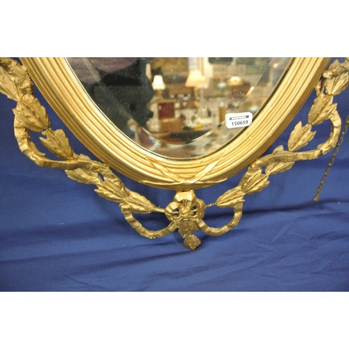 142 - Regency style oval bevelled glass gilt framed wall mirror with ornate foliate scroll & reeded decora... 