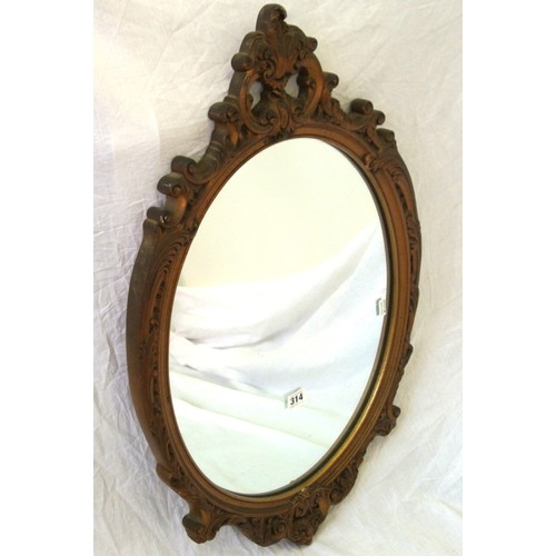 314 - Oval gilt framed wall mirror in an ornate scroll pierced frame